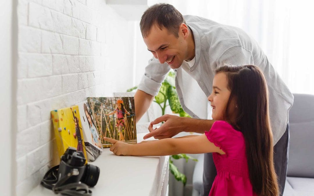 father and daughter hold photo canvas in the interior